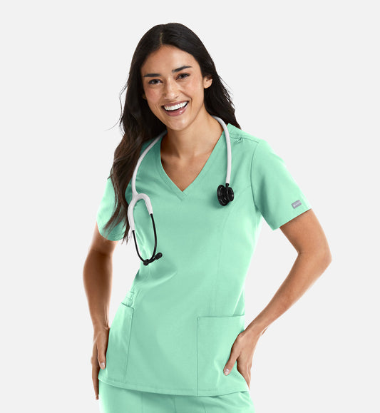 Woman wearing Maevn Momentum V-Neck Scrub Top in Opal with stethoscope – modern fit medical uniform